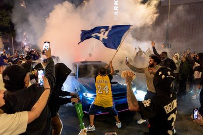 Bus set on fire and at least a dozen arrested in Los Angeles as rowdy fans celebrate World Series win