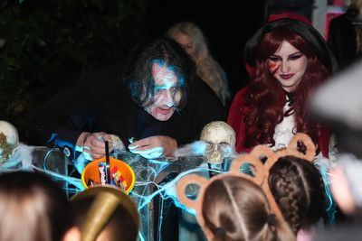 Jonathan Ross delights trick-or-treaters with sweets outside his London home