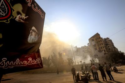 Portraits Of Slain Leaders Watch Out On Hezbollah's Battered Beirut Bastion