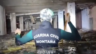 Spain floods: Rescuers wade through building’s chest-high water in search for missing