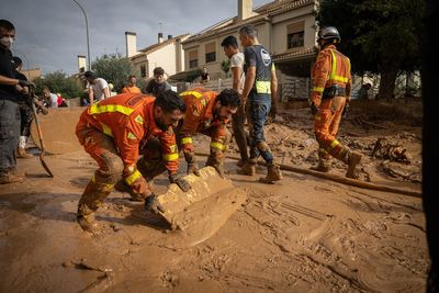 Spain deploys 15,000 police and troops to help flood relief – as vigilante protection groups patrol streets