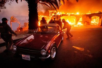 Raging wildfires force thousands of Californians to evacuate as homes go up in flames