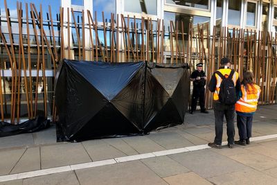 Climate activists clamp themselves to Scottish Parliament building