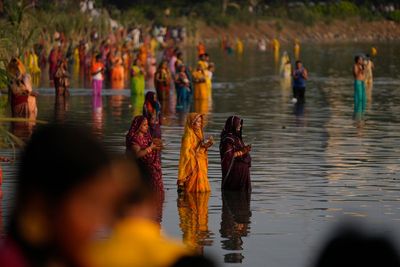 AP PHOTOS: Tens of thousands of Hindu devotees flock to rivers for prayers to the sun god