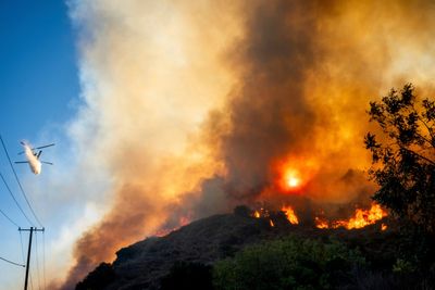 Raging mountain fire threatens airport in California as smoke billows above runway