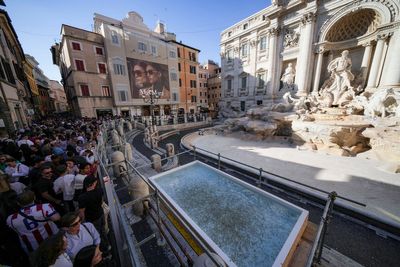 Tourists in Rome now have a walkway to visit the Trevi Fountain but can't toss coins