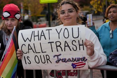 Migrants march New York streets in Trump protest clutching ‘here to stay’ signs