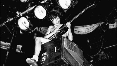 “There was some madman running around inside the hall with a meat cleaver, chopping into people!”: How Angus Young remembered AC/DC’s scariest gig