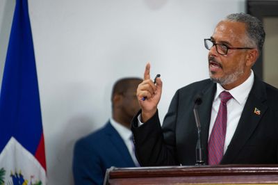 Haiti swears in new PM as gunfire at airport hits flight from US