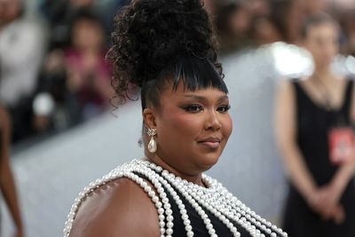 Lizzo claps back at critics who mocked her pen grip and suggested she's on Ozempic