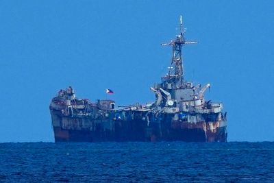 Chinese and Philippine forces again avoid a clash in a fiercely disputed shoal under a rare deal