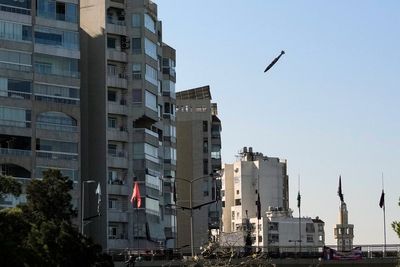 AP PHOTOS: An AP photographer captures a bomb falling on a building in his childhood neighborhood