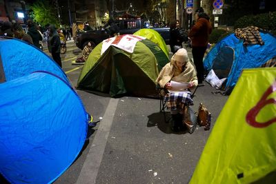 Protesters in Georgia's capital set up a tent camp on the main street and call for new elections