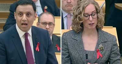 Why are politicians wearing red ribbons at FMQs?