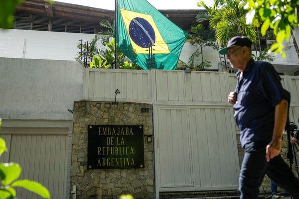 Sheltered Venezuelan government opponents decry police and intelligence agents outside embassy