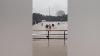 Footballers turn flooded Gloucestershire pitch into swimming pool