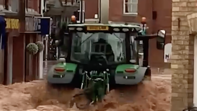 Tractor creates devastating wave by driving through flooded UK town