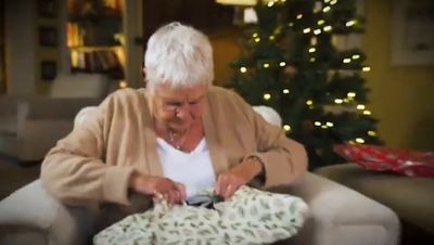 Judi Dench left red-faced after opening charity Christmas present