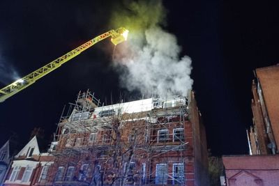 Around 100 firefighters tackling takeaway, flat blaze