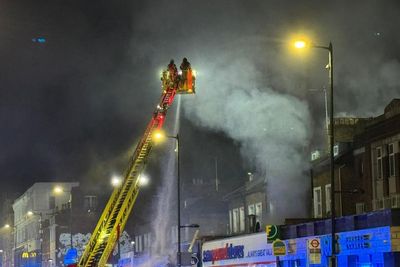 Five people in hospital after fire breaks out at takeaway and flats