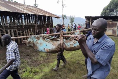 At least 15 killed, more than 100 missing as landslides bury Uganda homes