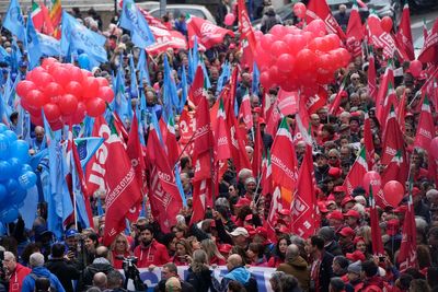 Thousands of workers march across Italy in general strike demanding better pay and services