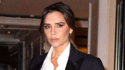 Victoria Beckham transforms her signature black power suit into party wear with a sultry lace bodysuit