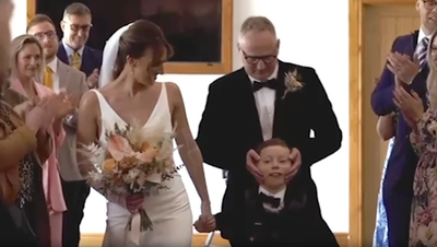 Disabled boy fulfils dream of walking mother down aisle at her wedding