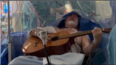 “They asked me to bring in my guitar and I was woken up part way through my surgery and played different tunes”: Guitarist plays acoustic… during brain operation