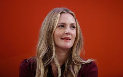 Drew Barrymore uses white lights and red ornaments to create a 'warm and cozy' Christmas atmosphere setting that's endlessly classic