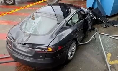 Runaway Tesla crashes into three cars and drives off rooftop at Sydney shopping centre car park