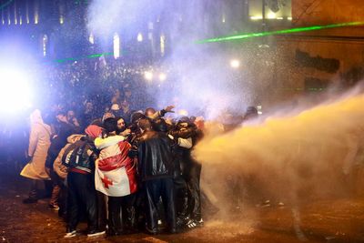 What is happening in Georgia and why are people holding massive protests outside parliament?