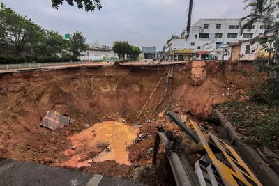 Rescuers search for 13 workers missing after a railroad construction site collapses in south China