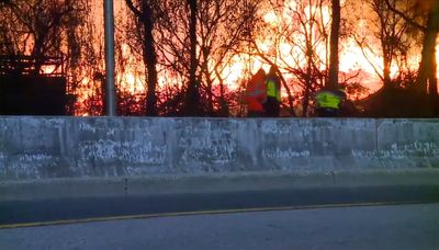 Firefighters finally contain massive Baltimore brush fire that closed roads and rails with thick smoke