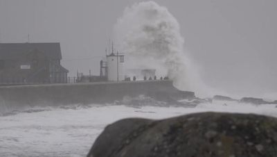 Storm Darragh watchers line harbour as 10-foot waves crash against wall
