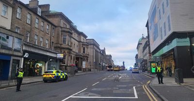 Police close two city centre streets following a crash involving a bus and a man