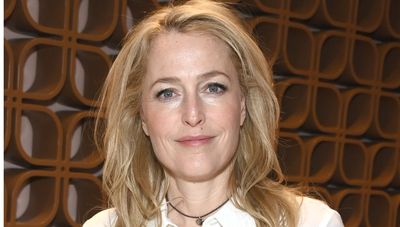 We're shopping Gillian Anderson's stylish navy jumper and black pleated skirt for the festivities ahead