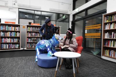 Queen praises community resilience as library torched during riots reopens