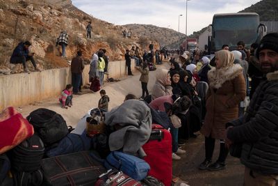 Thousands queue to flee Syria as ethnic minorities fear post-Assad future