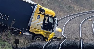 Man charged after lorry crashes onto railway line