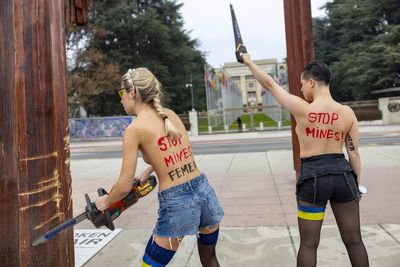 Topless women protesting the Ukraine war are detained for vandalizing sculpture near UN building