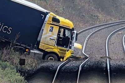 Man charged after lorry crashes onto railway line