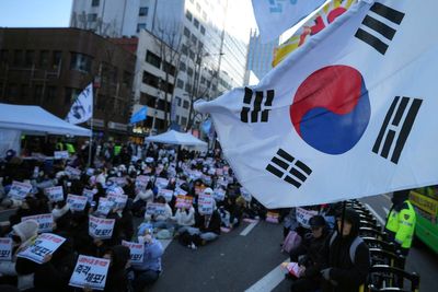 South Korean investigators request impeached president to appear for questioning over martial law