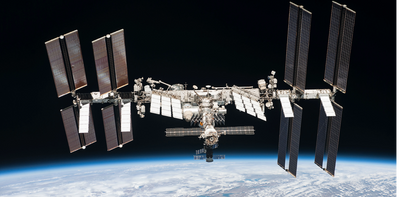 How does the International Space Station orbit Earth without burning up?