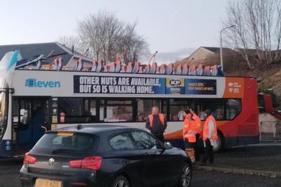 Eight taken to hospital after roof of bus ripped off in bridge crash