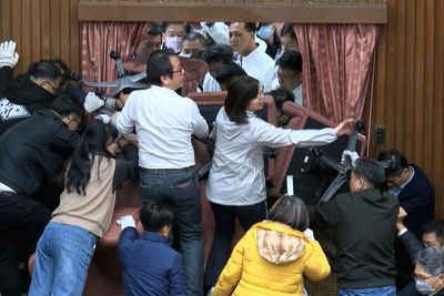 Taiwan lawmakers clash after party members break into legislature to occupy speaker's chair