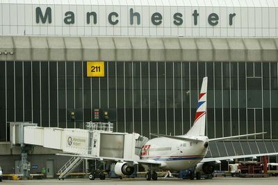 Two men charged with assaulting police after Manchester Airport incident