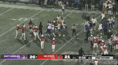 A referee took a helmet to the face during Military Bowl brawl between ECU and NC State