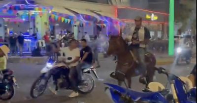 Watch partying Alfredo Morelos ride a horse down busy city centre street