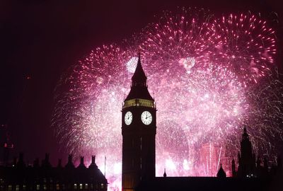 Revellers cheer in New Year around world despite bad weather forcing cancellations in UK